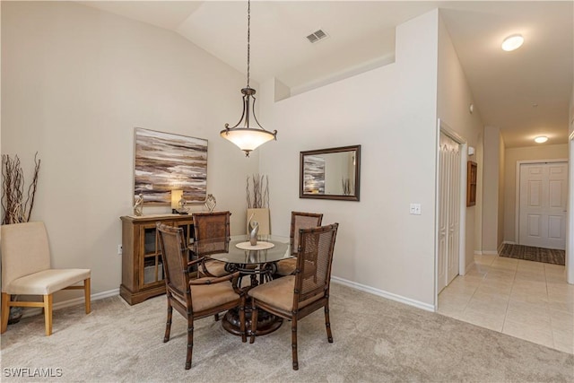 dining space with lofted ceiling, light tile patterned floors, light colored carpet, visible vents, and baseboards