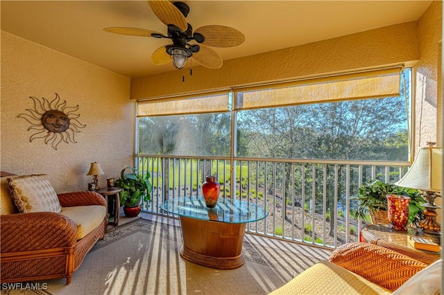 sunroom featuring ceiling fan