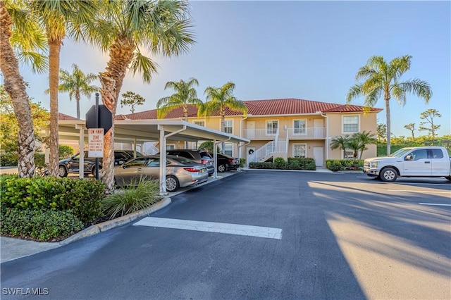 partially covered parking lot featuring stairway