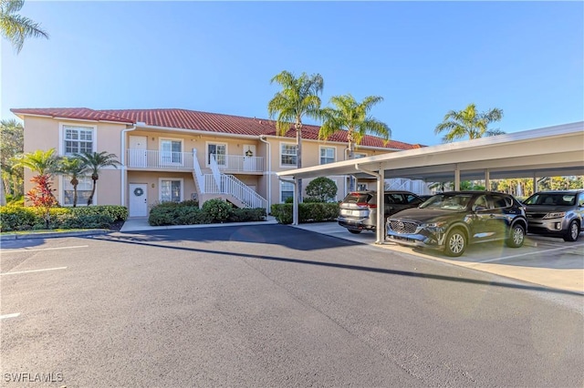 2895 Cypress Trace Cir Unit 202, Naples, FL 34119 - view of property featuring covered parking and stairway