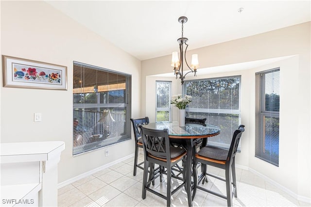 dining room featuring a wealth of natural light, a notable chandelier, baseboards, and light tile patterned floors