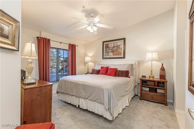 bedroom with light colored carpet, ceiling fan, and baseboards