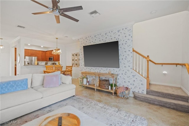 living room with ceiling fan with notable chandelier, light tile patterned flooring, and ornamental molding