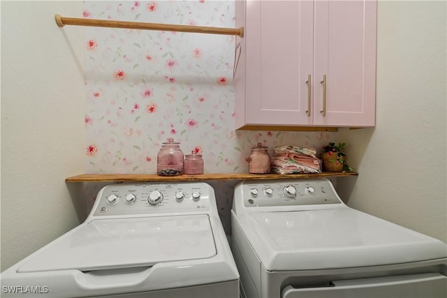 laundry room featuring cabinets and separate washer and dryer