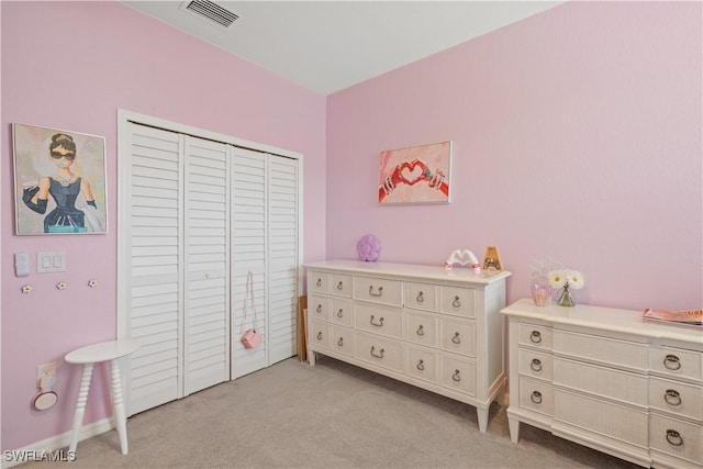 carpeted bedroom with a closet