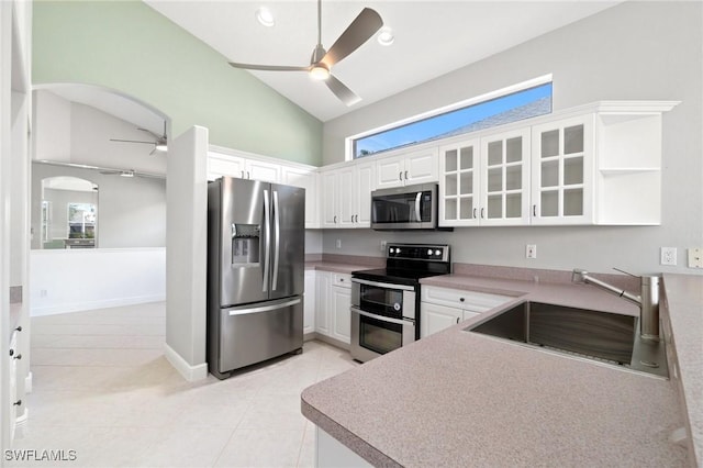 kitchen featuring light tile patterned floors, white cabinetry, sink, and appliances with stainless steel finishes