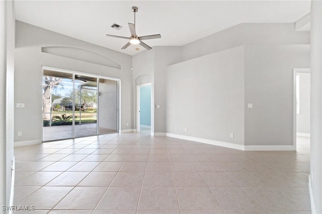 tiled spare room with ceiling fan and vaulted ceiling