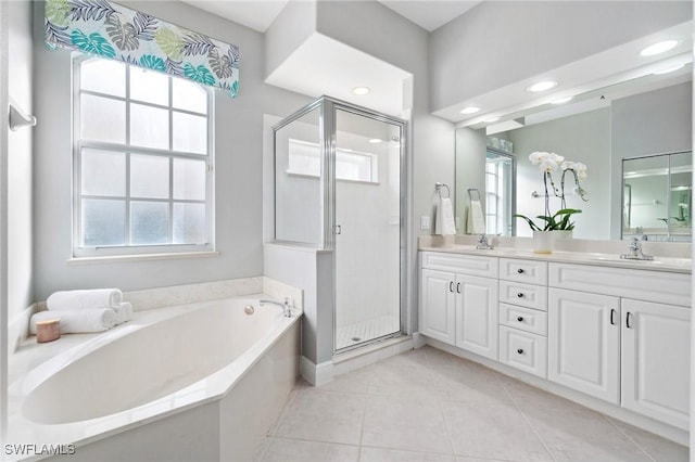 bathroom with vanity, plenty of natural light, and plus walk in shower