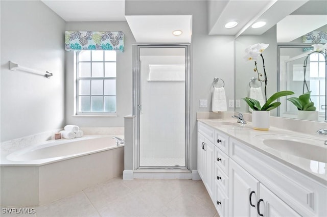 bathroom with tile patterned flooring, vanity, and shower with separate bathtub