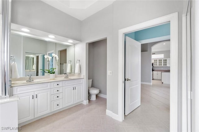 bathroom featuring tile patterned floors, vanity, and toilet