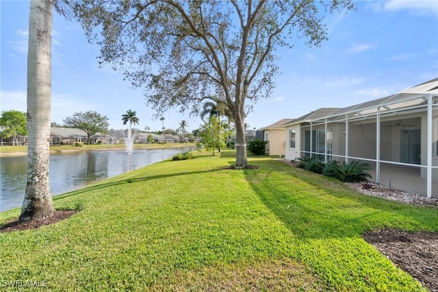 view of yard featuring a water view and glass enclosure