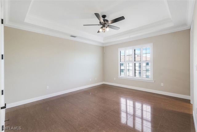 unfurnished room featuring a raised ceiling, crown molding, and ceiling fan