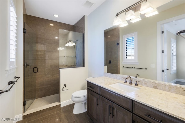 bathroom with walk in shower, vanity, and toilet