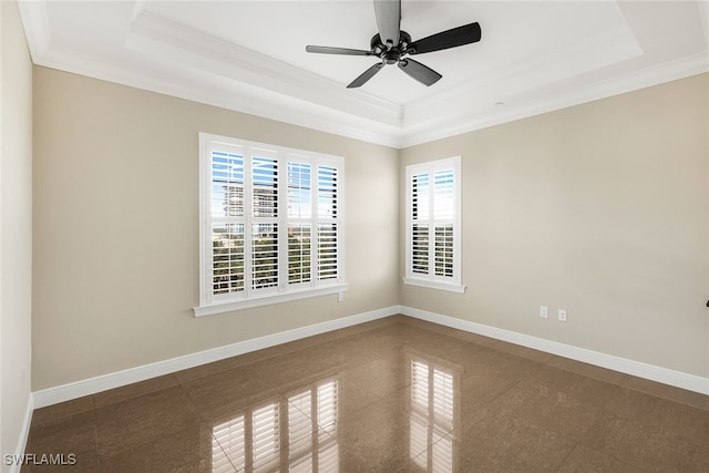 spare room with ornamental molding, a raised ceiling, and ceiling fan