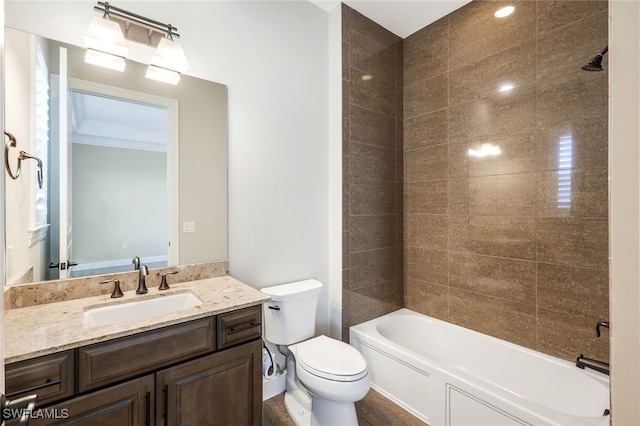 full bathroom featuring vanity, toilet, and tiled shower / bath