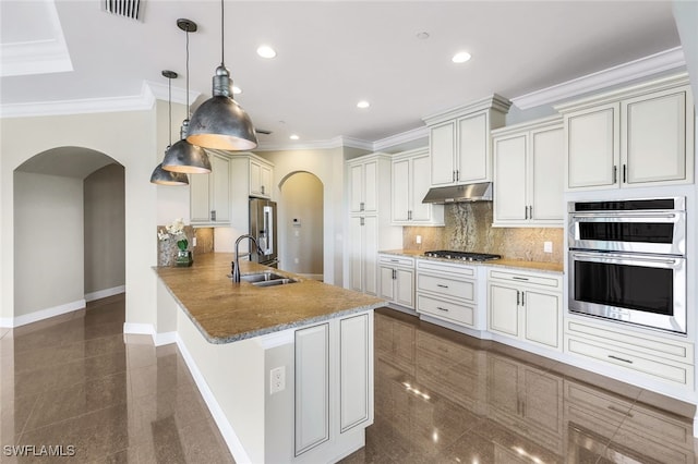 kitchen with sink, stone countertops, hanging light fixtures, kitchen peninsula, and stainless steel appliances