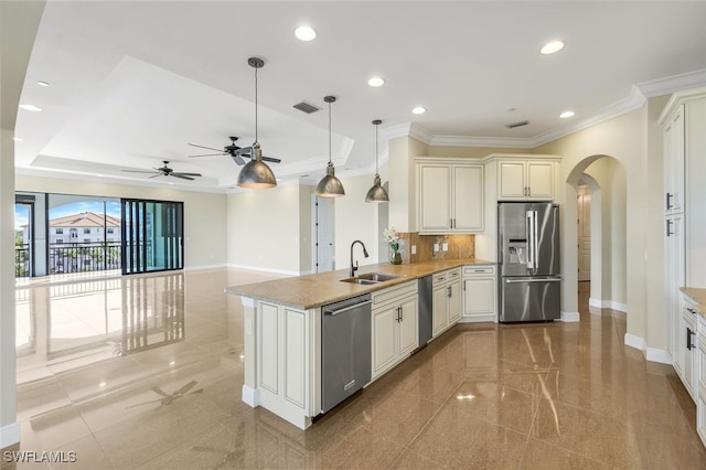 kitchen featuring sink, crown molding, appliances with stainless steel finishes, hanging light fixtures, and kitchen peninsula