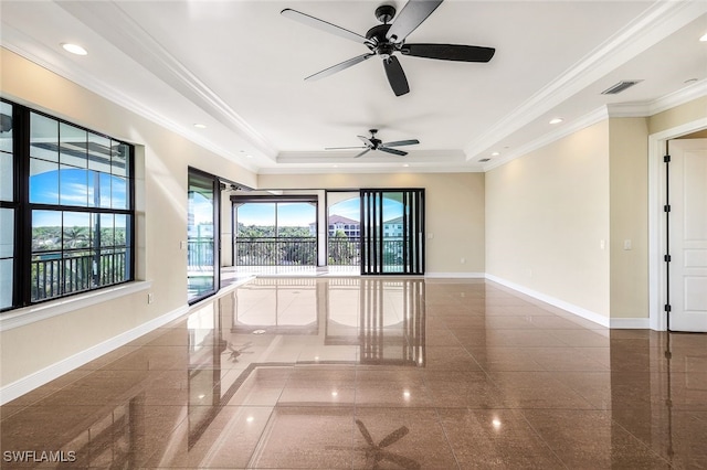 spare room with crown molding and a raised ceiling