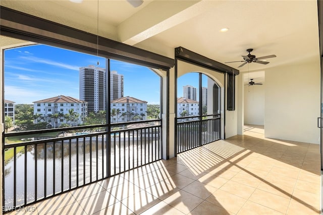 unfurnished sunroom featuring a healthy amount of sunlight and a ceiling fan