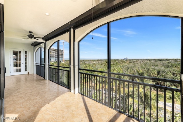 sunroom featuring ceiling fan