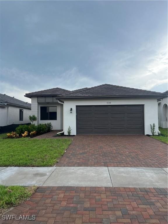 view of front facade featuring a front yard and a garage