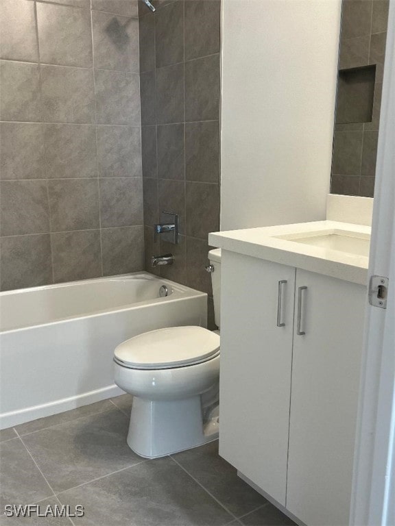 full bathroom with tile patterned flooring, vanity, toilet, and tiled shower / bath combo