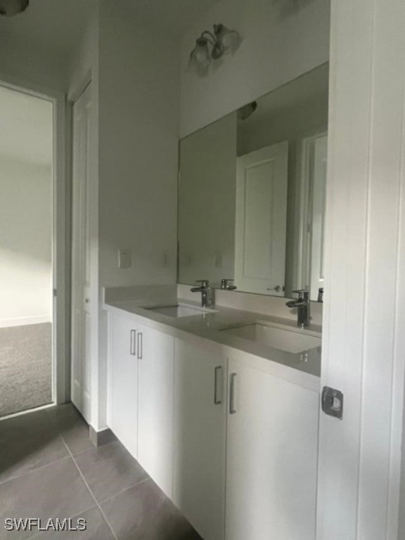 bathroom with tile patterned flooring and vanity