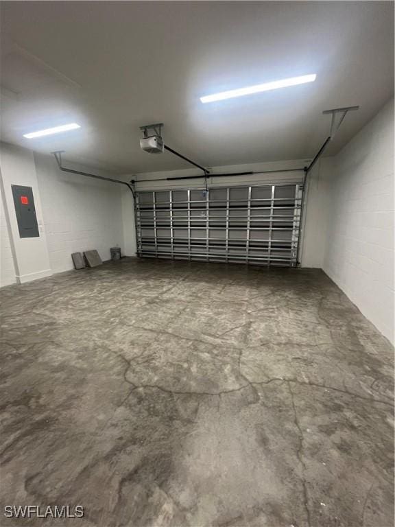 garage with electric panel and a garage door opener