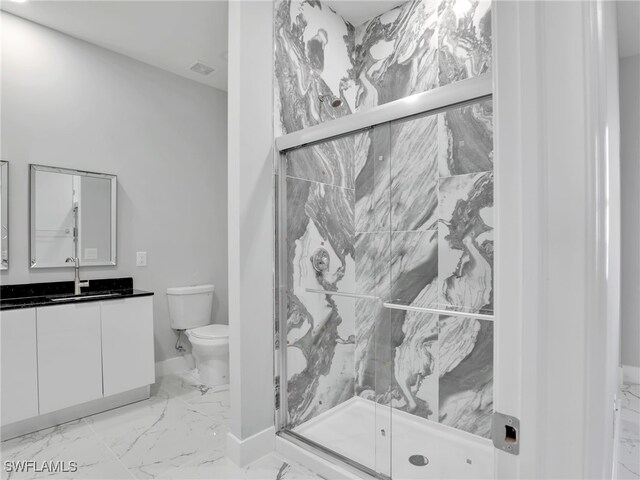 full bath with toilet, vanity, baseboards, marble finish floor, and a marble finish shower