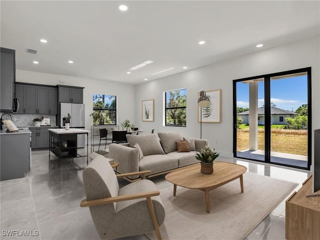 1423 NW 20th Ter, Cape Coral, FL 33993 - living room featuring recessed lighting and light marble finish floors