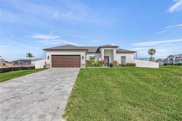 view of front of property featuring a front lawn and a garage