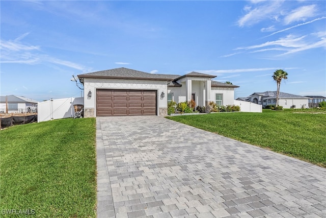 view of front of property featuring a front lawn and a garage