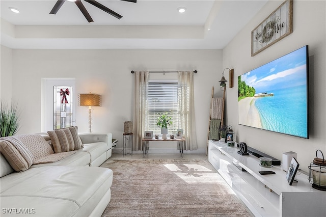 living room featuring ceiling fan and light colored carpet