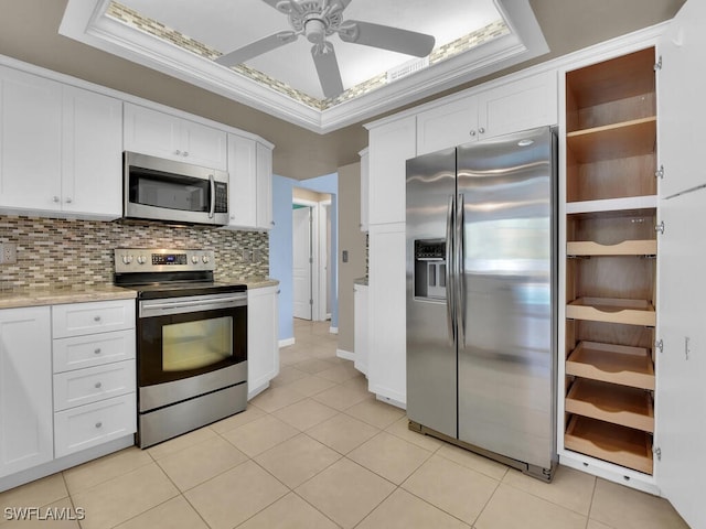 kitchen featuring decorative backsplash, appliances with stainless steel finishes, ceiling fan, crown molding, and white cabinets