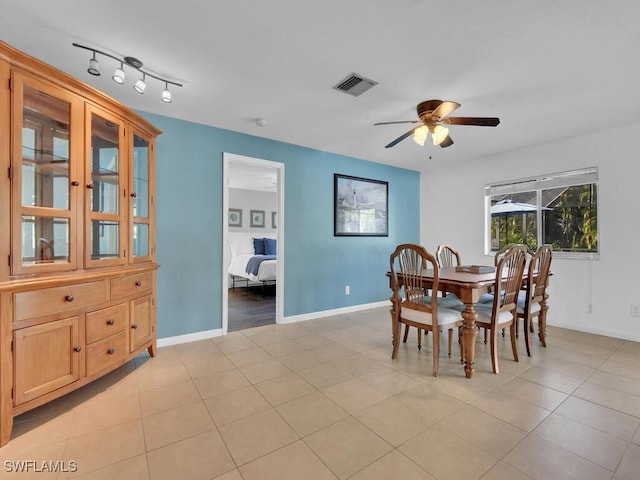 tiled dining space featuring ceiling fan