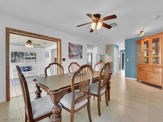 tiled dining space with ceiling fan