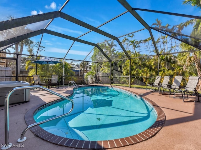 view of swimming pool featuring a lanai and a patio