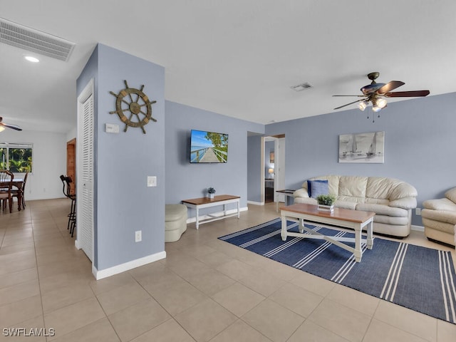 tiled living room with ceiling fan