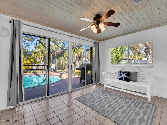 doorway with ceiling fan, light tile patterned floors, and wooden ceiling