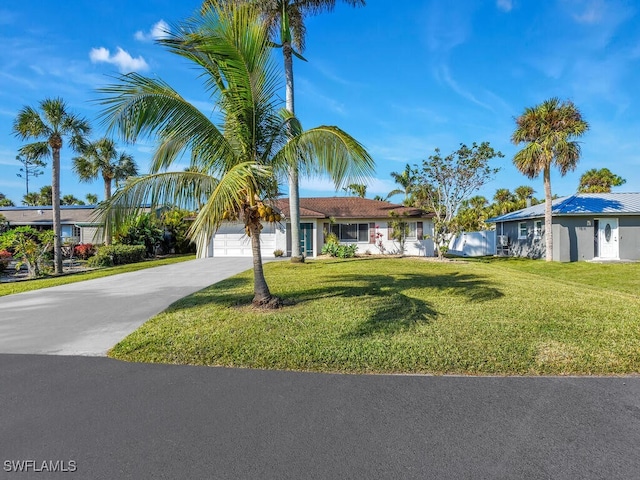 view of front of property featuring a garage and a front lawn