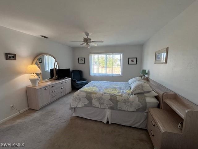 bedroom with a ceiling fan, visible vents, light carpet, and baseboards