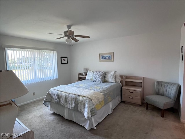 carpeted bedroom featuring ceiling fan and baseboards