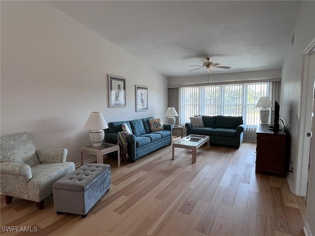 living room featuring light wood-type flooring and a ceiling fan