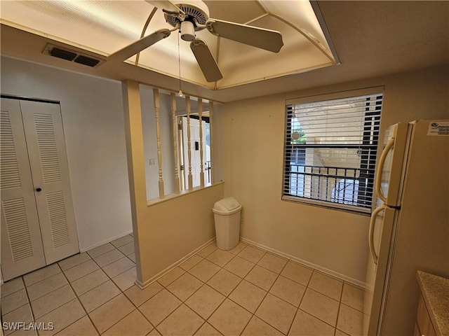 interior space with tile patterned floors and ceiling fan