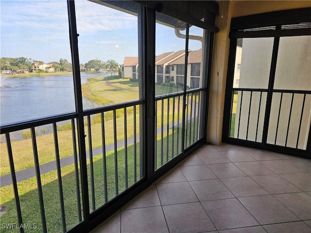 unfurnished sunroom with a water view