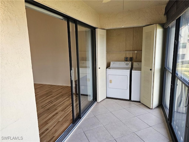 laundry room featuring independent washer and dryer and light tile patterned flooring