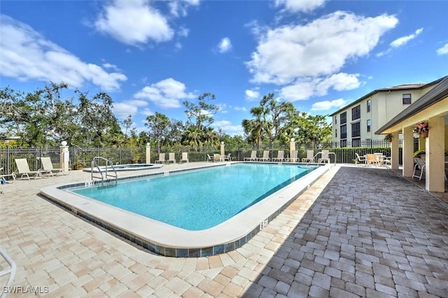 view of pool with a community hot tub and a patio