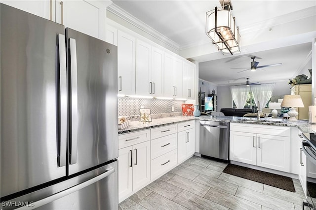 kitchen with appliances with stainless steel finishes, backsplash, white cabinetry, and light stone counters