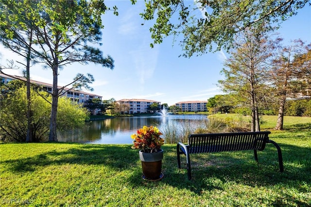 exterior space with a water view and a lawn