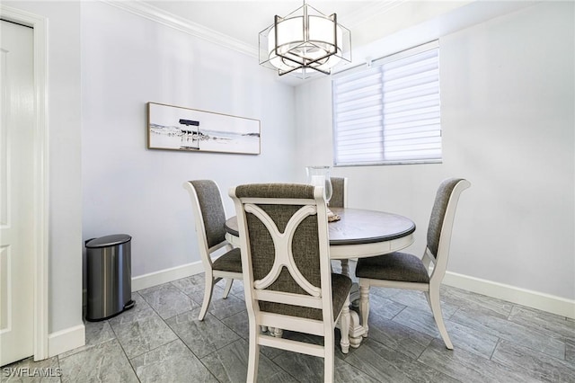 dining space featuring an inviting chandelier and crown molding